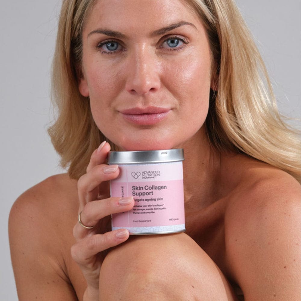 woman sat with collagen skin support tablets